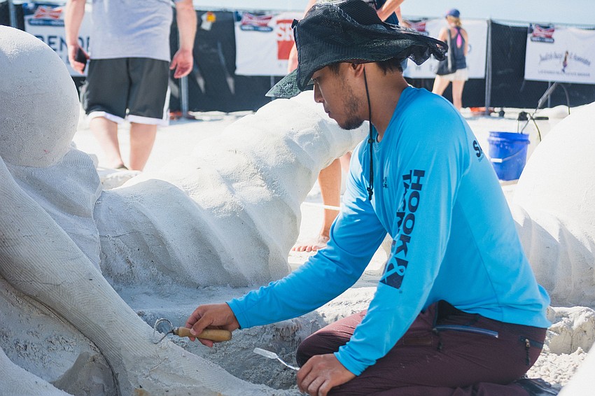 DaeYoung Ji of South Korea works on a team sculpture called 