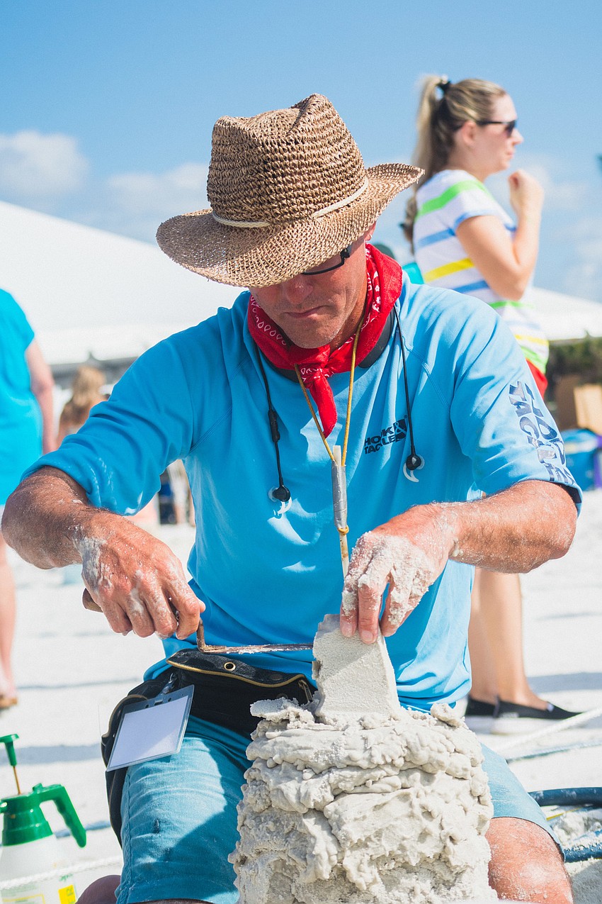 Delayne Corbett of Canada works on a team sculpture inspired by circus clowns.
