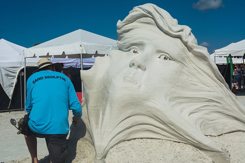 Jeff Strong works on his sculpture in the solo artist category.