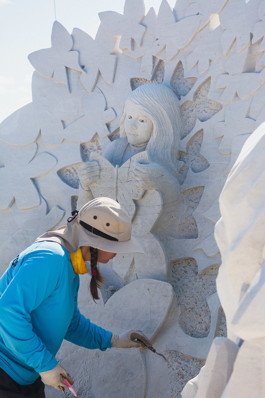 Karen Fralich of Canada works on her team's sculpture, 