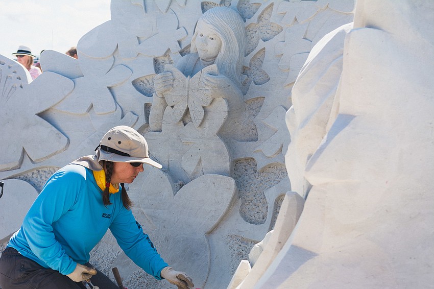 Karen Fralich of Canada works on her team's sculpture. Fralich has made sand sculpting a full-time career for 16 years.