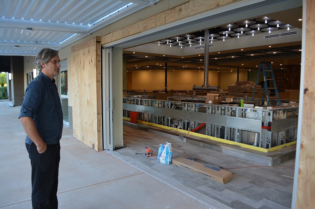 Greg Campbell stands just off Lakewood Main Street. The Grove&#39;s new main bar will be open to the street through two huge pocket doors at the corner of the building.