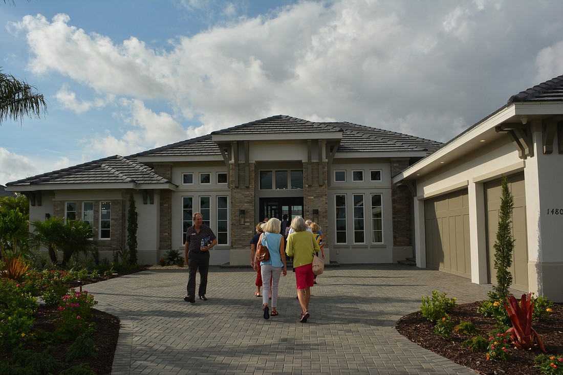 Potential homeowners check out a model in the Lake Club&#39;s Lake View Estates neighborhood.