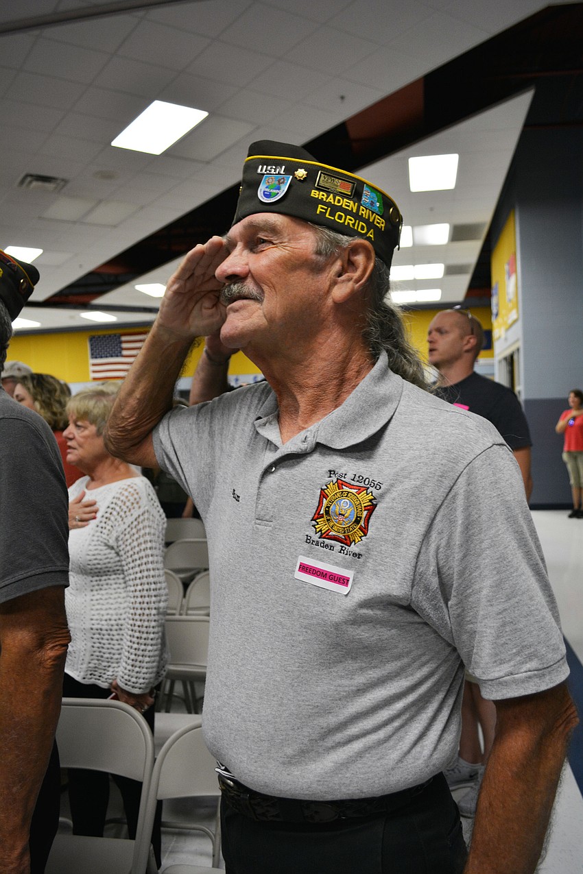 VFW Post 12055 member Graham Ellis, who served in the U.S. Navy for 21 years, stands for the Pledge of Allegiance.