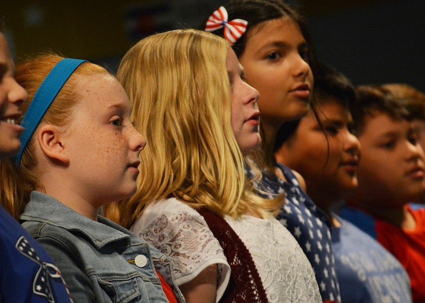 Olivia Michaels, Julia Miller and Maya Noon-Rajal perform a patriotic song. They know all the words.