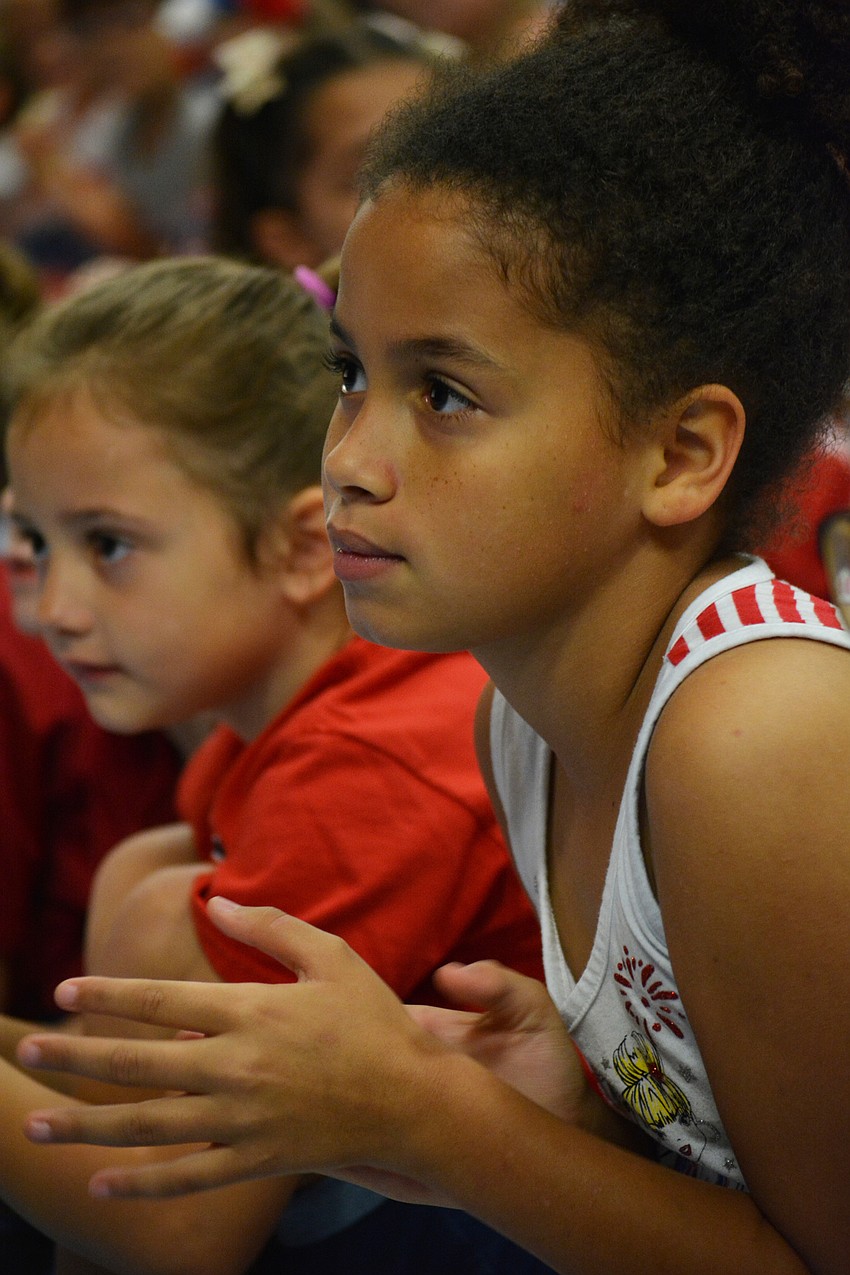 Ma'Kala Hull claps after hearing guest speaker John Krotec share about what freedom means to him.