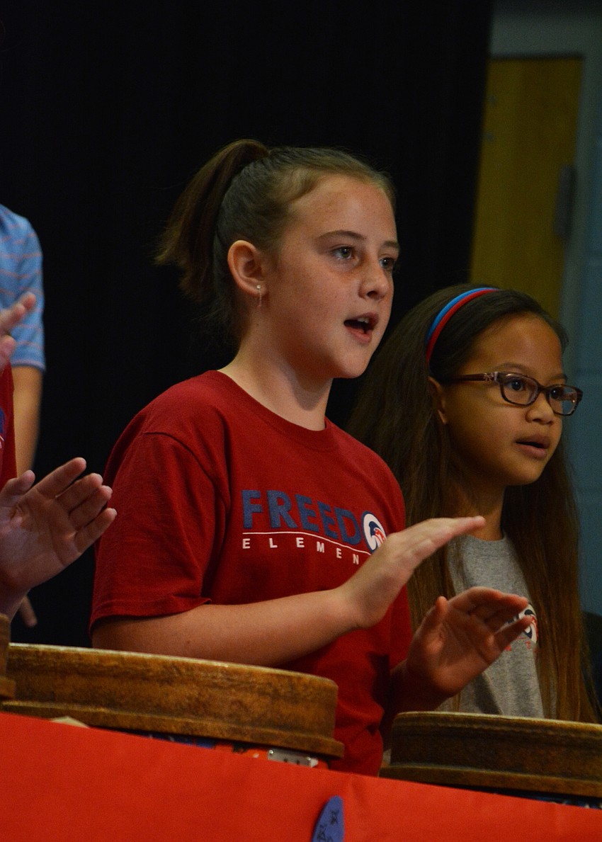 Micah Parsley, front, keeps rhythm for patriotic number.