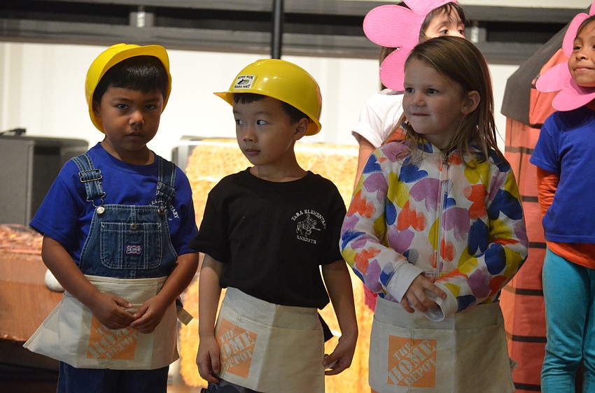 Manny Breton, the straw salesman in the play, Elvis Chen, the stick seller and Raelynn Wilson, the brick seller, each set their prices during the play in an improv style.