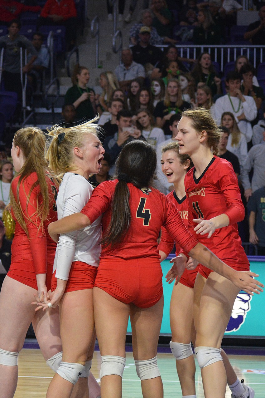 The Cougars celebrate winning a big point in the first set.