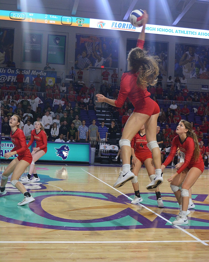Cougars junior Sophia Hritz smashes a pass from sophomore Alex Lopez.