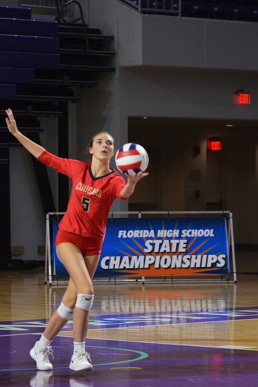 Cougars sophomore Kara Klemeyer serves against Trinity Catholic.