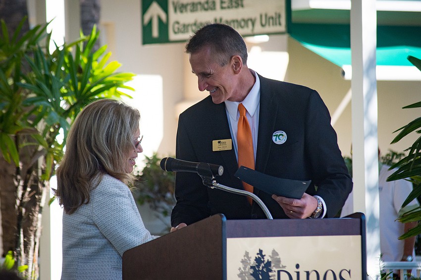 Sarasota Mayor Liz Alpert gives board chairman Peter Abbott a city proclamation.