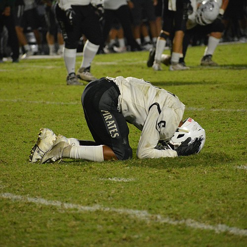 Pirates junior running back Brian Battie holds his head in his hands after Braden River&#39;s comeback attempt fell just short.