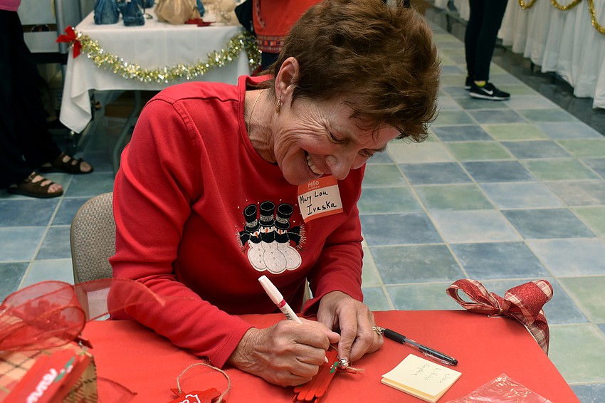 Mary Lou Ivaska personalizes toboggan ornaments.