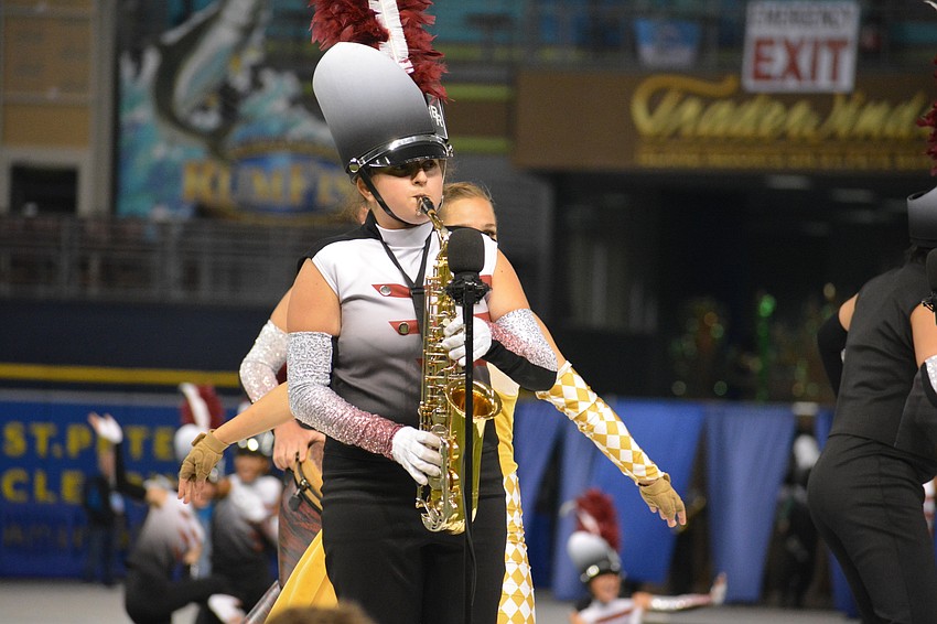 Junior Jessica Baus plays a solo on her saxophone during the opening number.
