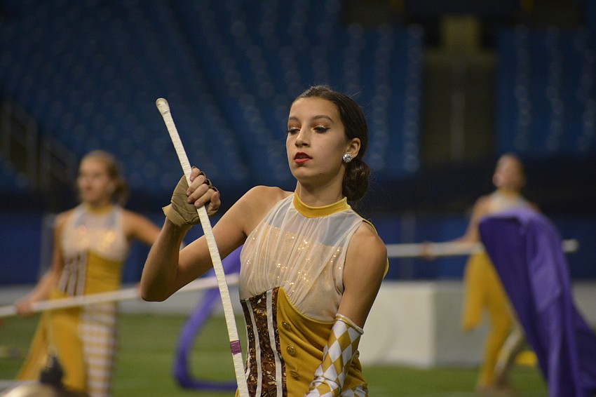 Sophomore Nicole Stratford has to throw her rifle into the air and catch it, all while performing in the number.