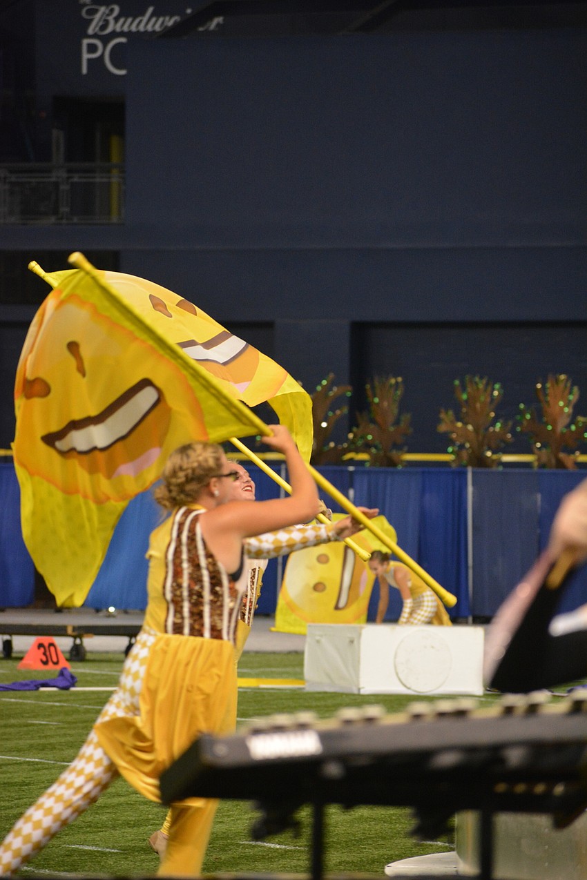 The color guard members twirled flags with emojis on them, representing emotions in a more modern way.
