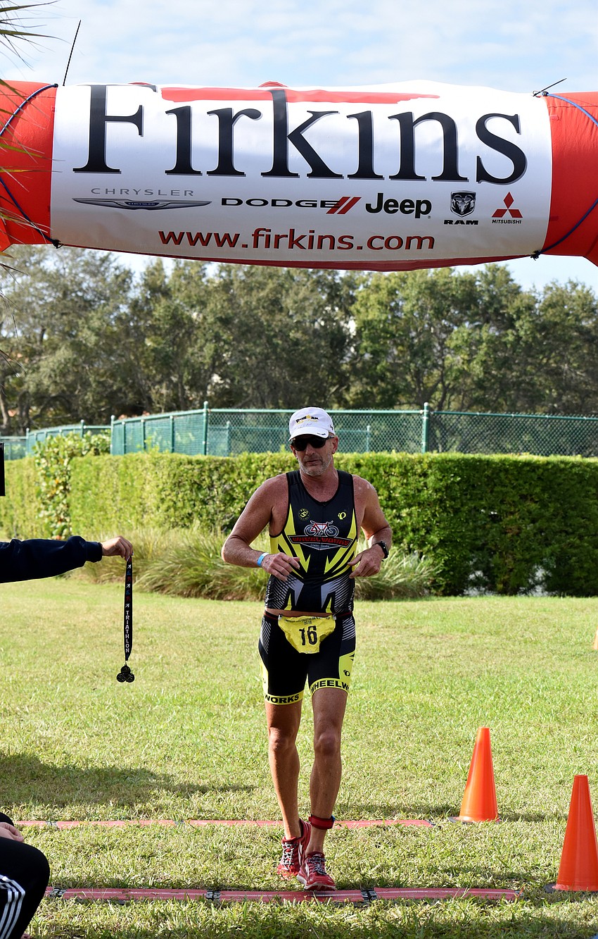 As athletes finished the triathlon or duathlon, they were handed medals.