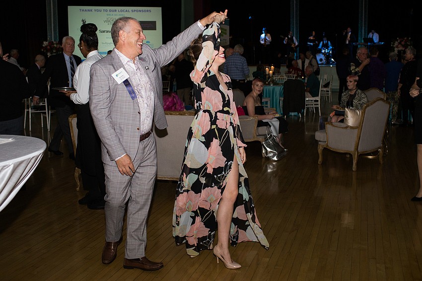 Dona and Emma Raker dance to the band music.
