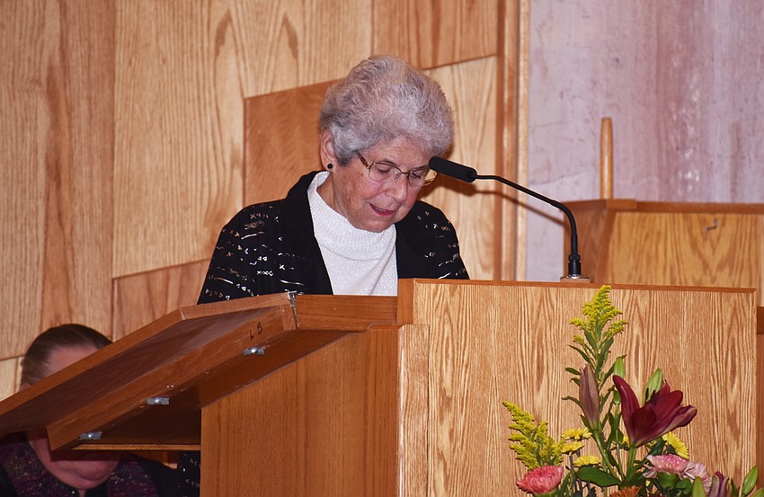 Longboat Island Chapel Pastoral Care Assistant MiMi Horwitz reads from the scripture.