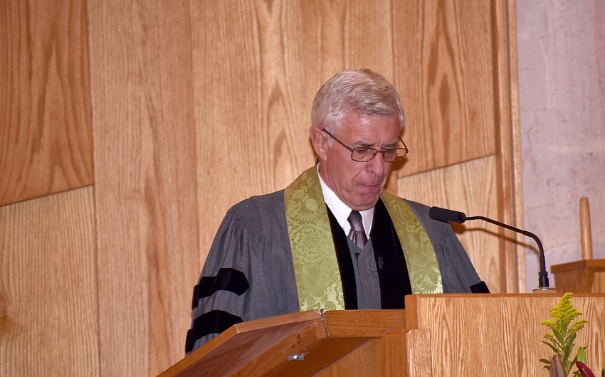 The Rev. Norman Pritchard reads from the scripture.