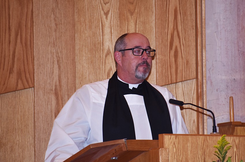 The Rev. Kenneth Blyth delivers a sermon to the crowd.