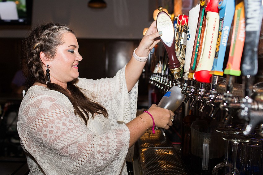 Lauren Jackson pours beer from the tap.