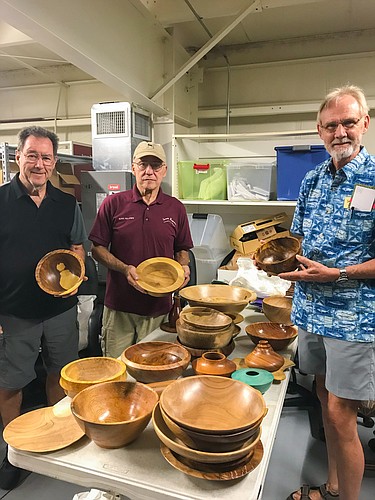 Russ Fellows, center, and other members of the Sarasota Woodturners with the wooden bowls they contributed to this year&#39;s Bowls of Hope event.