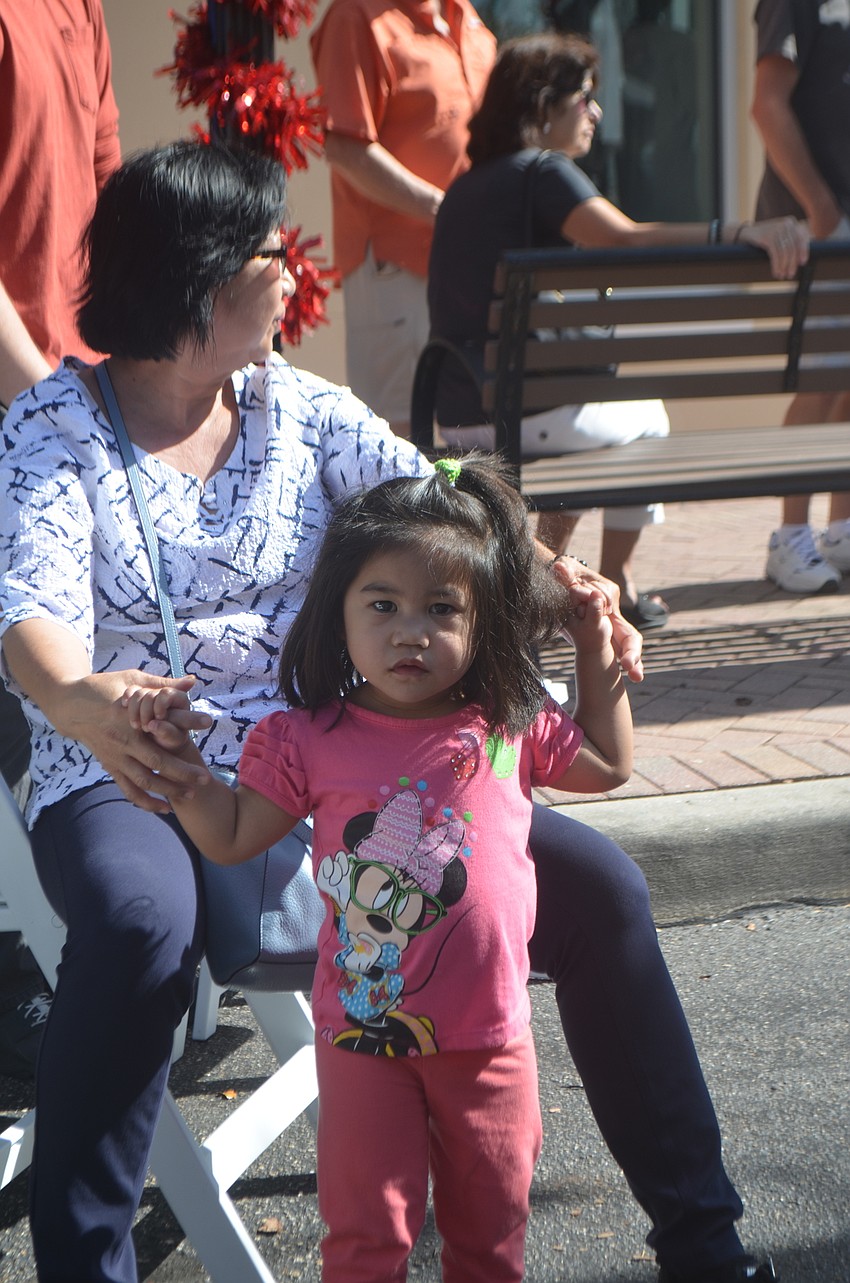Sarasota's Teres Quijano, 2, dances with her grandmother, Fraish Batilo to the music at the festival.