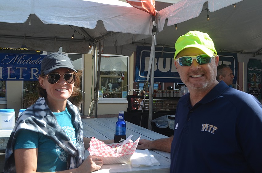 Edgewater's Bar Burk and Mike Burk grab a shrimp po-boy sandwich to eat.