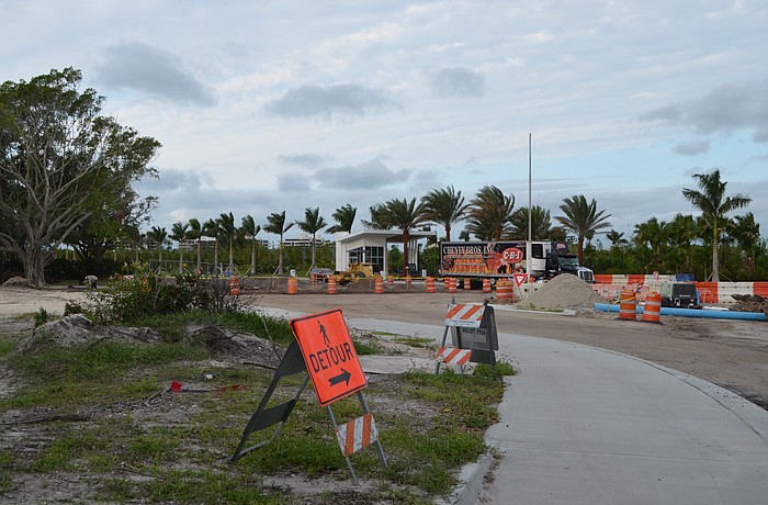 Vehicles still have to wind around construction debris.