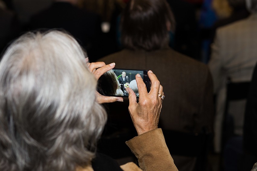 Guests took videos and photos on their phones during the ceremony.