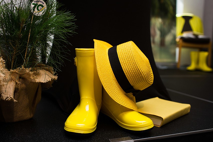 A Pines of Sarasota video featuring a woman in yellow inspired the decor for the stage.