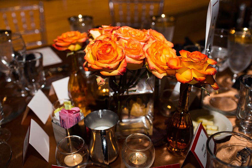 Orange roses centered the tables.