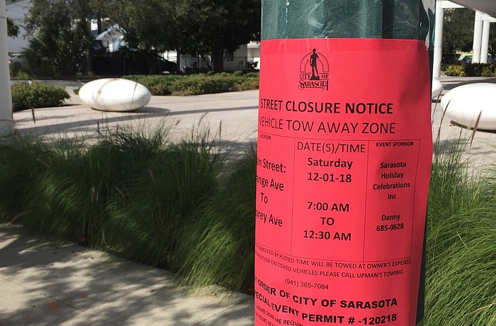 The city posted advisory signs along Main Street about parking restrictions and road closures for Saturday's parade.