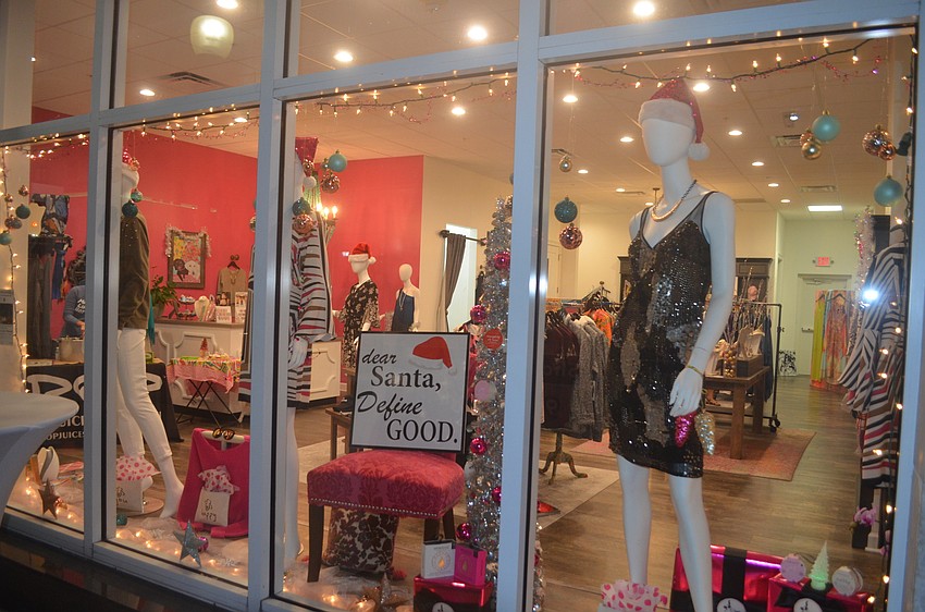 Scout & Molly's Boutique on First Street get into the holiday spirit with their window display.