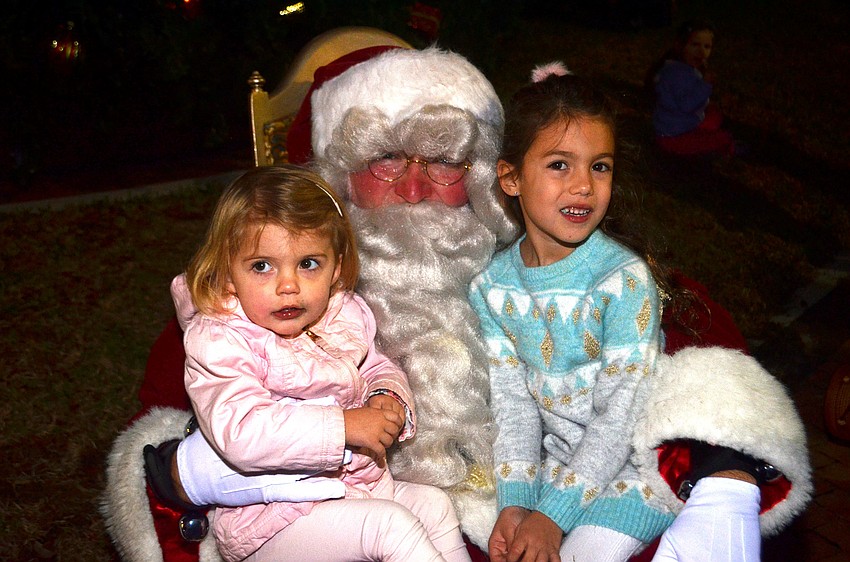 Veda Krolik and Rhea Krolik take a picture with Santa.