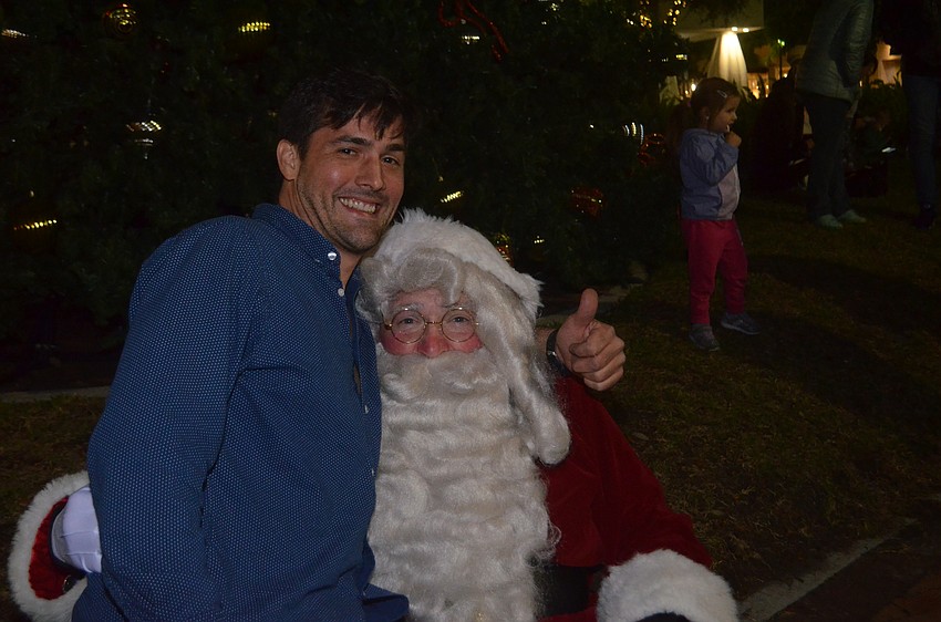 Dana Stoltzner snuggles up to Santa.