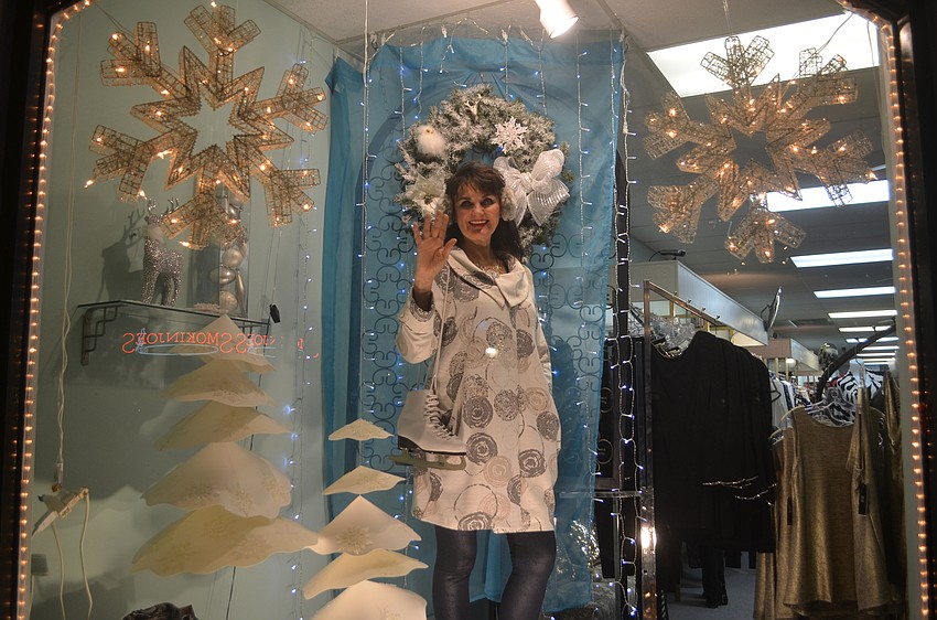 Irina Nadolyn-Kouchnir is a living mannequin in the front window display at PJ's Boutique.