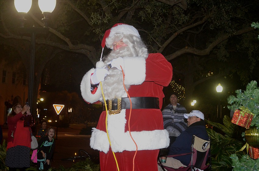 Santa plugs in the tree to begin the tree lighting.