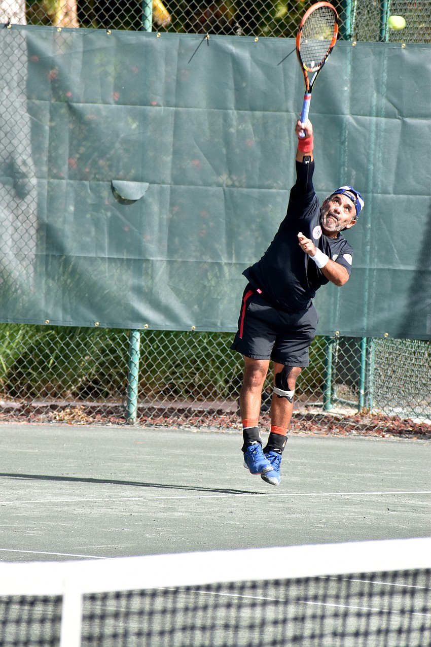 Tomas Blanno serves the ball during his Friday match against Steven Garman.
