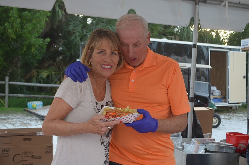 Russ Rusakov and Jill Rusakov marvel at the lobster rolls they served at the seafood fest from Made in Italy in Venice.
