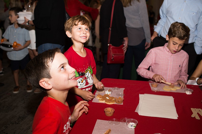 Caden and Graham Ankele smile for a photo with their cookies.