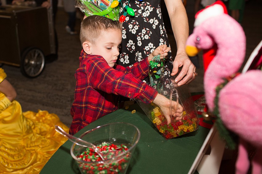 Asa Congdon reaches into the bowl for more candy.