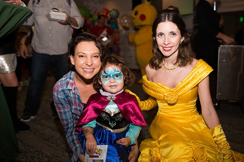 Alicia and Alison Dragash smile for a photo with Belle.