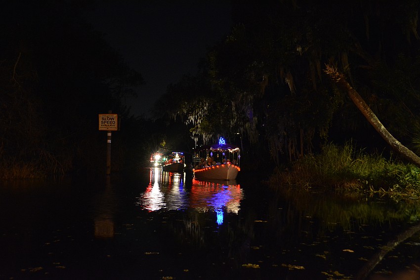 About six motor boats, decorated in Christmas lights, arrived at Linger Lodge shortly after 7 p.m. They left from Jiggs Landing and made their way down the Braden River.