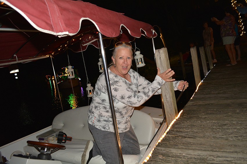 Braden River resident Denise Kleiner, a parade founder, ties up the lead boat.