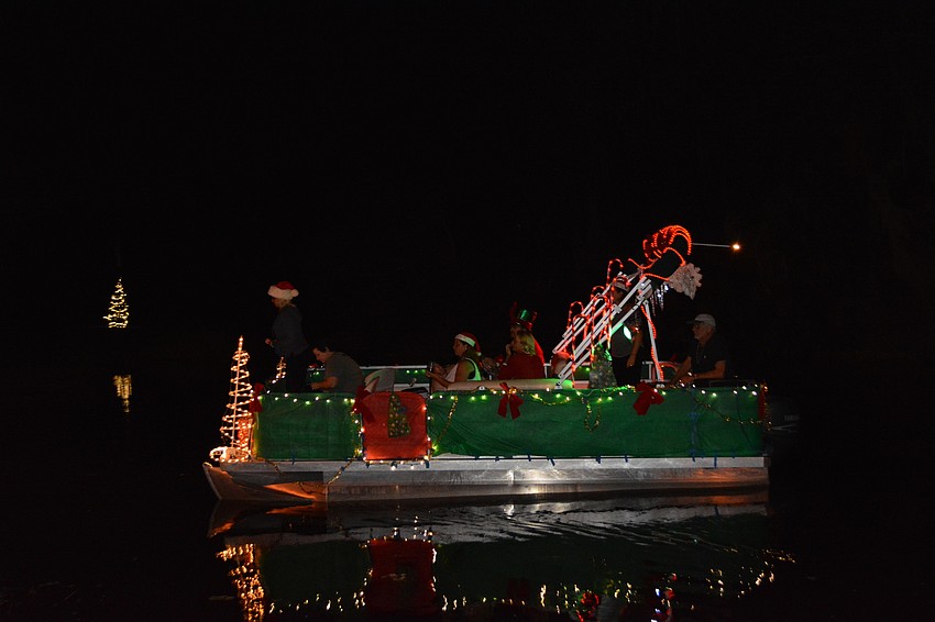 Boats decorated in holiday decor and Christmas lights arrived at Linger Lodge around 7:15 p.m.