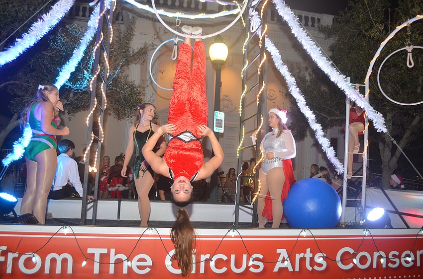 Sailor Circus' Emily O'Neill strikes a pose before the floats begin to move.