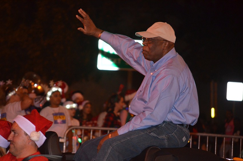 Willie Charles Shaw, city commissioner, waves to people along the parade route.